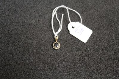a necklace with a tag attached to it on a table