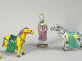 three figurines of a horse and a man on a horse