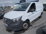 la camionnette blanche est garée dans le parking à côté d'autres voitures