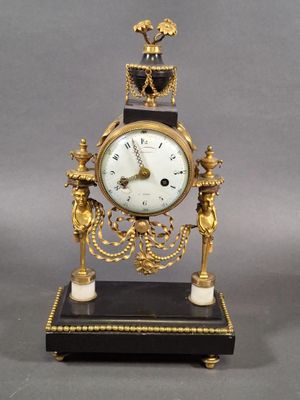 a gold clock with a crown on top of it