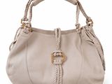 a close up of a handbag with a braid handle