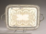an antique silver plate with a decorative design on it