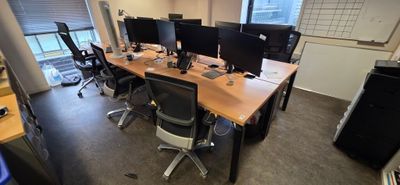 many computers on the desks in this office