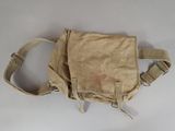 a tan bag with a handle on it on a white surface