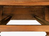 a close up of a wooden table with two legs on it