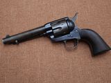 a close up of a revolver on a brown surface