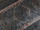 a cat that is laying on a rug on the floor
