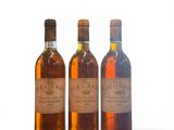 three bottles of wine sitting next to each other on a white surface