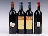 three bottles of wine are lined up on a white surface