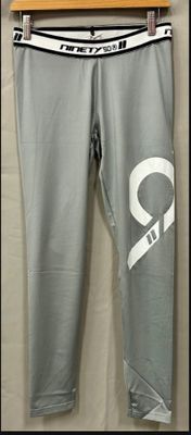 grey pants with white letters on them hanging on a hanger