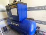 a blue air compressor sitting on top of a blue tank
