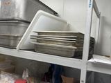 many pans and pans on the shelves in the kitchen
