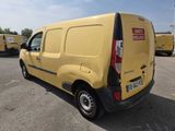 a yellow van that is parked in a parking lot