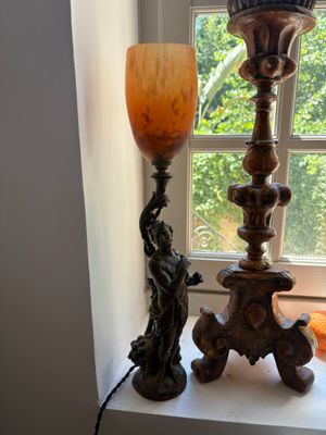 a lamp that is sitting on a window sill