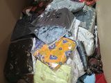 a cardboard box filled with many different types of clothing