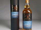 two bottles of whisky sitting next to each other on a table