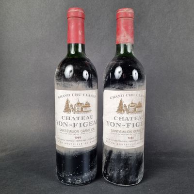 two bottles of wine sitting next to each other on a table