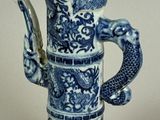 a blue and white vase with a dragon on it
