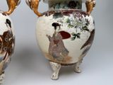 two vases with asian designs on them sitting on a table