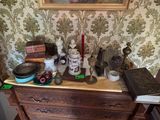 a picture of a dresser with a lot of items on top of it