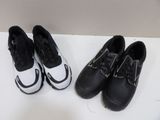 two pairs of black and white shoes sitting on top of a white table
