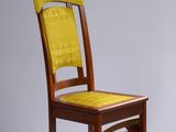 chaise en bois massif avec une assise rembourrée jaune