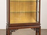 an old wooden display case with glass shelves on a wooden floor