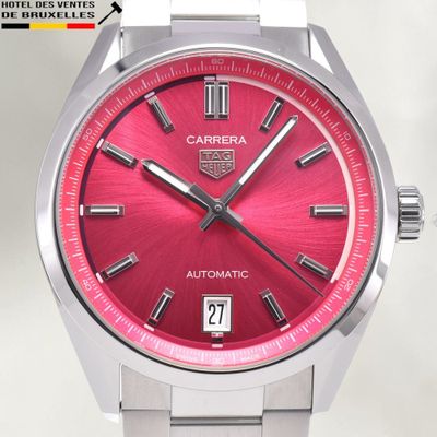 a close up of a watch with a red face