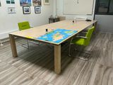 a long table with a map on it in a room