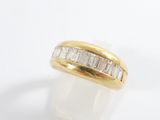 a yellow gold ring with baguets of diamonds