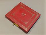 a red book with a star on it on a table