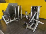 two machines that are sitting in the gym