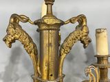 an image of a gold colored chandelier with two candles on it