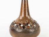 a brown vase that has a brown and white design on it