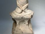 statue of a woman reading a book on top of a table