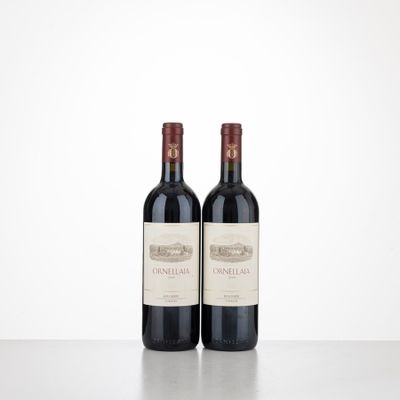 two bottles of wine sitting on top of a table next to each other