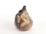a small vase with a painting on it on a white surface