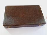 a brown leather case sitting on a white table