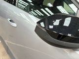 a close up of a car ' s side mirror and door handle