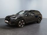 a black audi suv parked in an empty room
