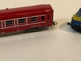 two toy trains sitting next to each other on a table