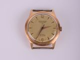 une image d'une montre-bracelet en or sur une surface blanche