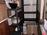 a small kitchen with a lot of items on the shelves