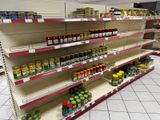 many jars of food on the shelves in the store