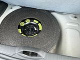 a black and yellow disc in the trunk of a car