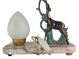 a statue of a horse on a stand next to a lamp