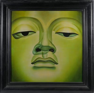 un tableau représentant un visage vert dans un cadre noir