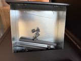 a metal box that has a small piece of metal in it