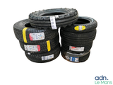 several tires stacked on top of each other on a white surface