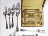 a lot of silverware on a table with a box